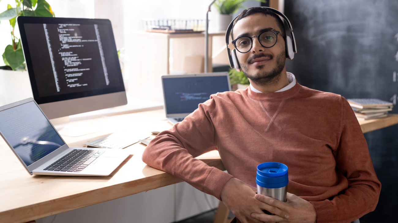 handsome-programmer-in-headphones-listening-to-mus-2023-11-27-04-56-48-utc